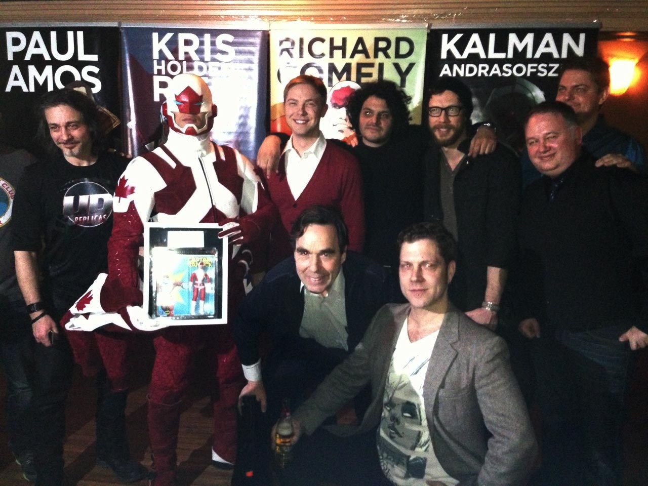 Canuck creator Richard Comely and the cast of the new animated series pose with the upcoming Odeon Toys Figure.